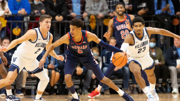 Nov 16, 2021; Villanova, Pennsylvania, USA; Howard Bison forward Steve Settle III (2) dribbles the ball against Villanova Wildcats guard Collin Gillespie (2) and forward Jermaine Samuels (23) during the first half at William B. Finneran Pavilion. Mandatory Credit: Bill Streicher-USA TODAY Sports
